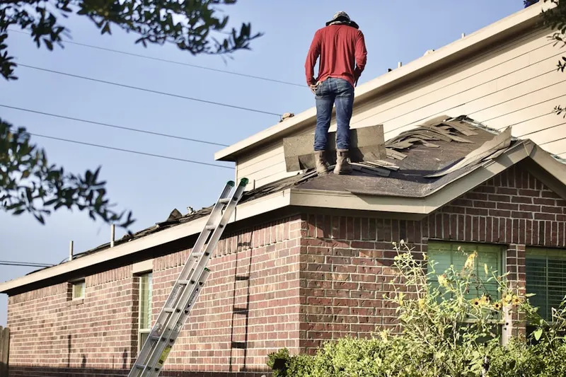 Professional roofer working on a residential roof in Brooks Mill